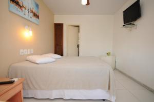 Een bed of bedden in een kamer bij Pousada Areias Brancas