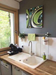 a kitchen counter with a sink and a window at Home 33 in Saint-Rémy-lès-Chevreuse +26 photos