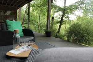a table with a bottle and glasses on a patio at Home 33 in Saint-Rémy-lès-Chevreuse
