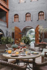 a table with glasses of orange juice on a patio at Pousada Castello Benvenutti in Bento Gonçalves
