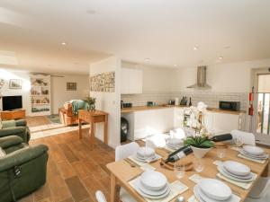 a kitchen and living room with a table and chairs at Oak Cottage in Sheffield