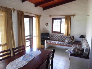 a living room with a couch and a table at Adi y Dina Cabañas in La Paloma