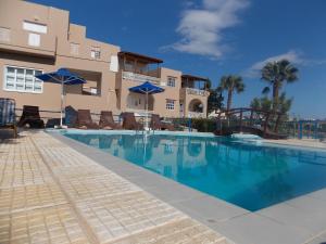a large swimming pool in front of a building at Nostalgia Villas in Tersanas