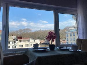 a table with a view of a city from a window at Garden House in Istanbul