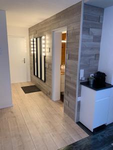 a living room with a wooden wall and a hallway at Roc d'Orsay E48 in Leysin