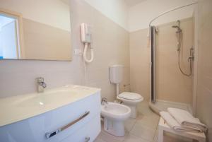 La salle de bains est pourvue d'un lavabo, de toilettes et d'une douche. dans l'établissement Hotel Residence Villa San Giovanni, à Portoferraio