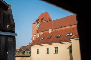 a large building with a clock tower on top of it at Gold Garden by Rentoom in Toruń