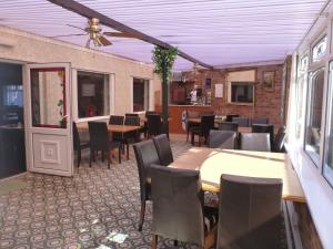 a dining room with tables and chairs in a restaurant at The Royal Bridlington in Bridlington