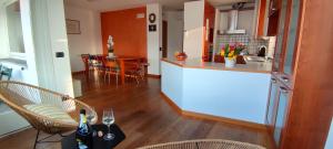 a kitchen and living room with a table and chairs at The Lake Apartment in Colico