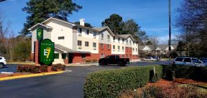 a building with a sign in front of a parking lot at Economy 7 Inn Chesapeake - Portsmouth in Chesapeake