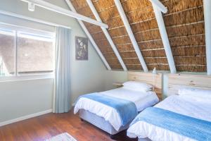 A bed or beds in a room at HERON at Cape St Francis Lifestyle Estate