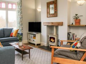 a living room with a couch and a fireplace at Willow View in Shrewsbury