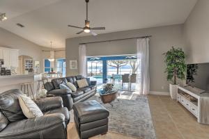 a living room with a leather couch and a tv at Dog-Friendly Lake Home with Dock about 25 Mi to Disney! in Clermont