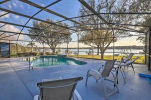a patio with chairs and a swimming pool at Dog-Friendly Lake Home with Dock about 25 Mi to Disney! in Clermont