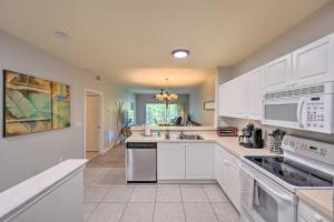 a kitchen with white cabinets and a sink at Quiet Lely Resort Condo with Pool - 2 Mi to Golf! in Naples