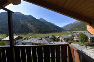 a view from a balcony of a village with mountains at Casa Fil in Cogne