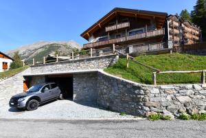 a car parked in a garage in front of a house at Casa Fil in Cogne
