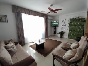 a living room with two couches and a ceiling fan at AnitApartman in Balatonfüred