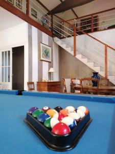 a pool table with balls in a living room at Domaine Des Deux Rivières in Meilhan-sur-Garonne