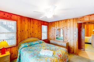 a bedroom with a bed and wooden walls at Harper House #4BB in Buxton
