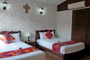 Postelja oz. postelje v sobi nastanitve Camino Mexicano Hotel & Resort