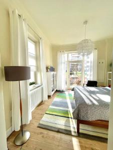 a bedroom with a bed and a large window at JETHON Studio-Appartement im Grünen in Bernburg