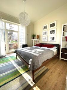 a bedroom with a large bed and a chandelier at JETHON Studio-Appartement im Grünen in Bernburg