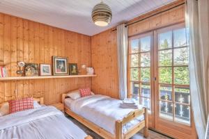 Postel nebo postele na pokoji v ubytování Le Chalet des Neiges - Welkeys