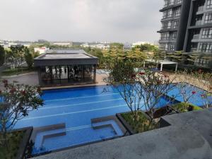 莎阿南POOLVIEW Geniehome 3BR Free100mbps and Carpark at Utropolis Shah Alam的城市中带凉亭的游泳池
