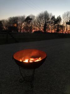 a fire pit in the middle of a field at The Shepherd's Hut in Mixbury