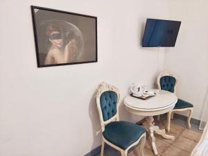a dining room with a table and two chairs at Pod Różą Economy in Łeba +12 photos