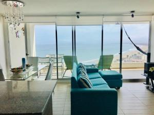 - un salon avec un canapé bleu et une table dans l'établissement La Choza VIP Turquesa en La Serena, frente al mar, à Coquimbo