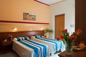Postel nebo postele na pokoji v ubytování Hotel Dolly
