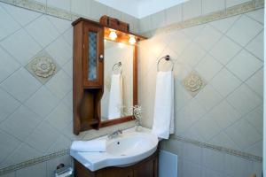 a bathroom with a sink and a mirror at Casa Serenata in Pinakokhórion +20 photos