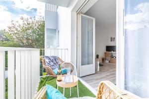 a balcony with a chair and a table on a patio at Waikiki in Biarritz