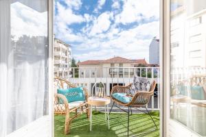 a balcony with two chairs and a table at Waikiki in Biarritz