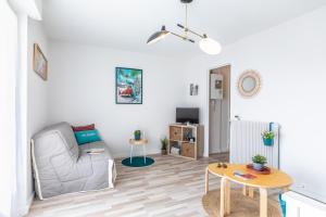 a living room with a couch and a table at Waikiki in Biarritz +32 photos