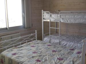 a bedroom with two bunk beds and a window at LES BALCONS ROUGES - FACE MER in Sainte-Cécile-Plage