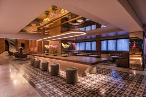 a lobby with a large table and chairs at Hotel Estelar La Fontana in Bogotá