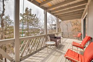 a screened in porch with chairs and a table at Resort Home with Hot Tub on Lake of the Ozarks! in Osage Beach