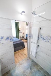 a bathroom with a mirror and a bed in a room at Green - Apartamenty Kleparskie in Kraków