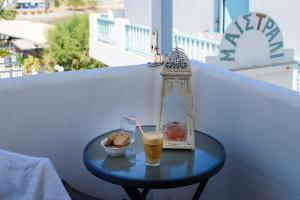 a small table with a drink and a bowl of food at Maistrali in Astypalaia