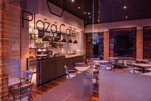 a restaurant with tables and chairs and a counter at Estelar Apartamentos Bogotá - La Fontana in Bogotá