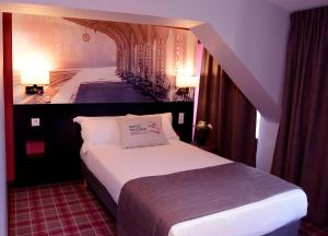 a hotel room with a bed and a staircase at Hotel Victoria Lyon Perrache Confluence in Lyon