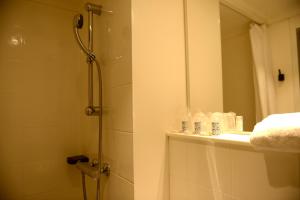 a bathroom with a shower and a mirror at Hotel Victoria Lyon Perrache Confluence in Lyon