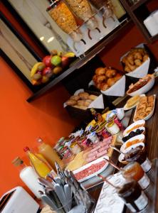 a buffet with many different types of food on display at Hotel Victoria Lyon Perrache Confluence in Lyon