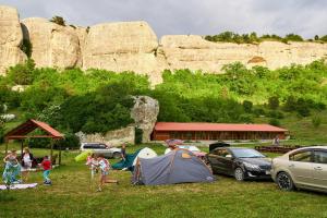 a group of people in a field with tents and cars at Эко Усадьба Эски Кермен in Bakhchysarai