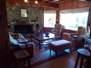 a living room with a couch and a fireplace at Casa Rincón Radales in San Martín de los Andes