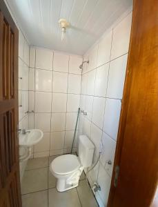 a bathroom with a toilet and a sink at Sanches Hotel in Campinas