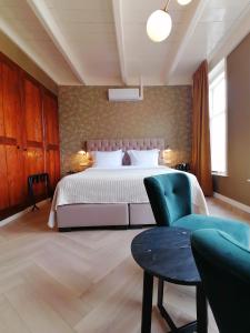 Un pat sau paturi într-o cameră la B&B De Stadssingel